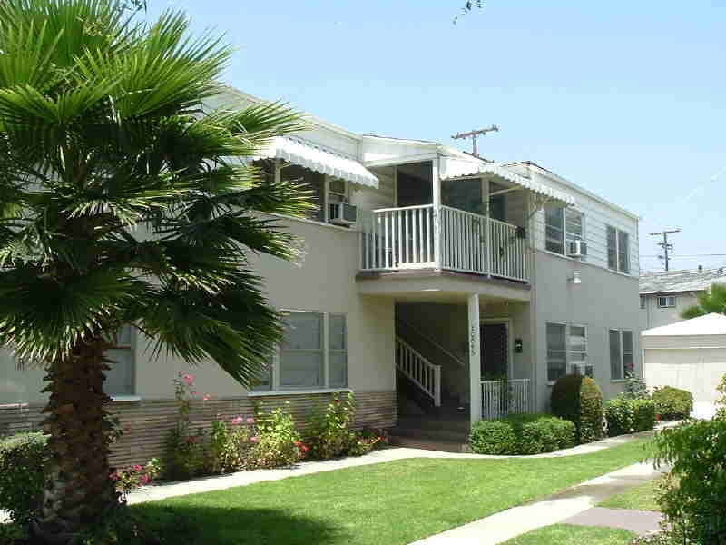 Valley Vintage two-story apartment building with palm tree and balcony